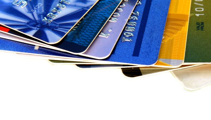 several multi-colored credit cards fanned out and a beginner's guide to credit card points
