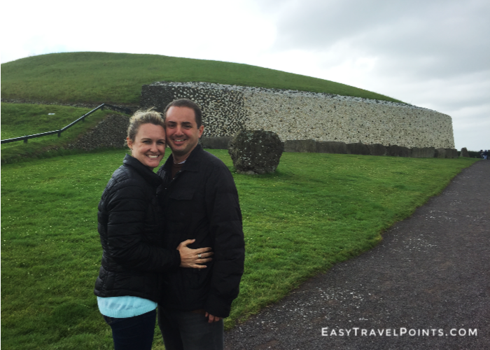 an attractive couple in front of Newgrange in Ireland